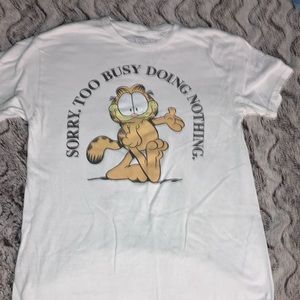 White Garfield shirt that reads, “ Too busy doing nothing” a classic.